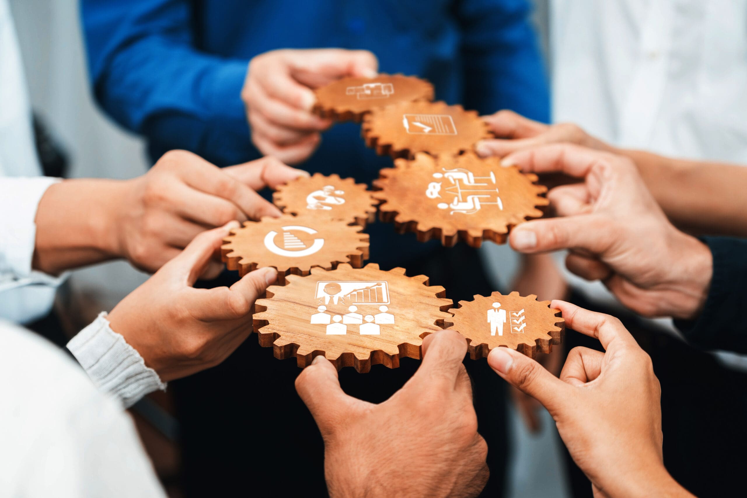 People holding gears to enable collaboration