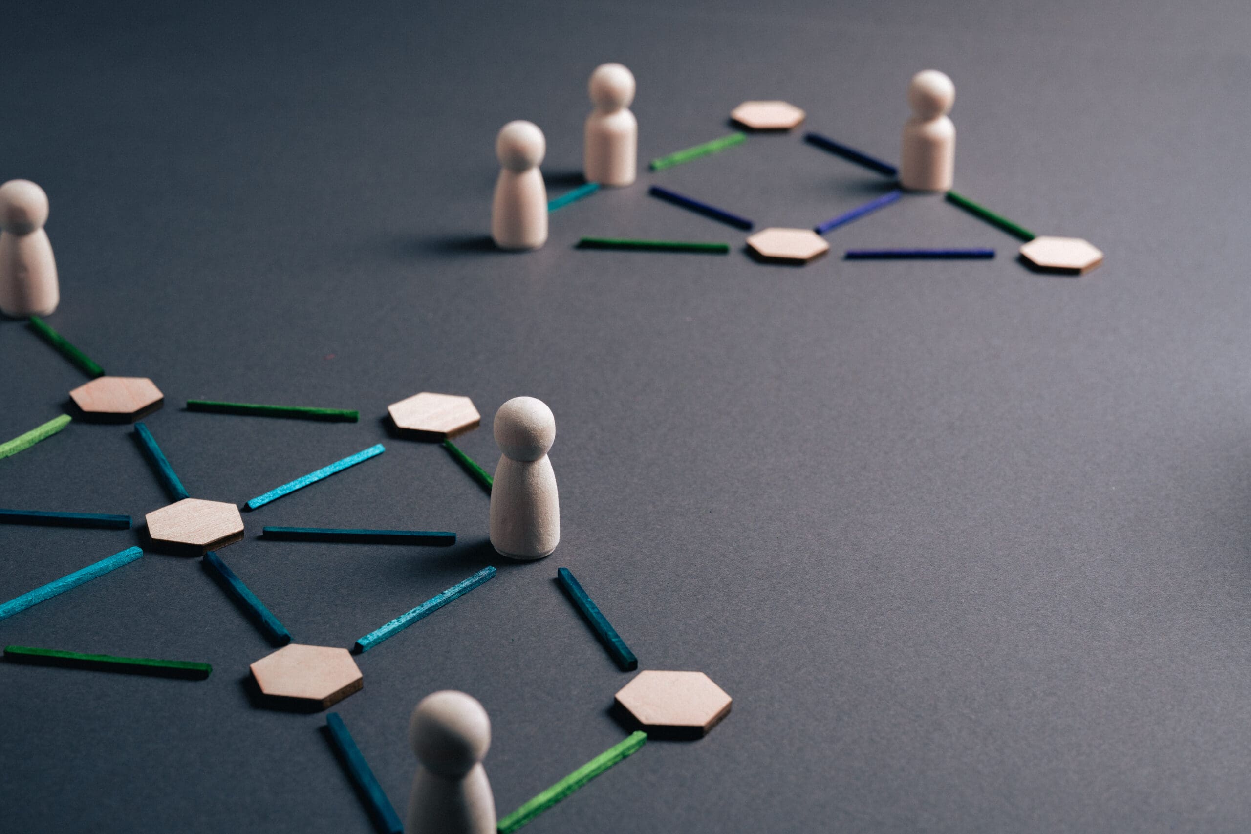 Wooden people pieces organized in two networks